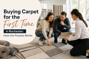 First-time carpet buyers in Rochester reviewing carpet samples with a flooring consultant.